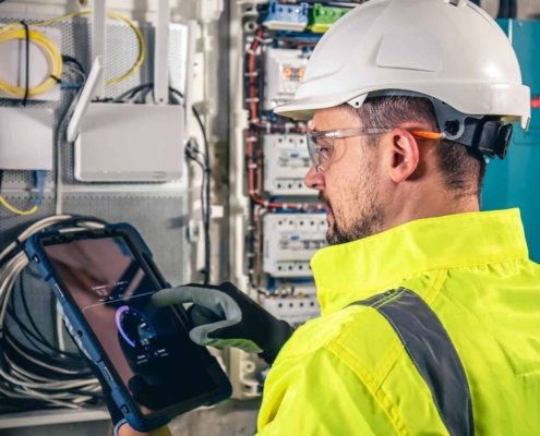 Image of a worker using a tablet to inspect building energy usage.
