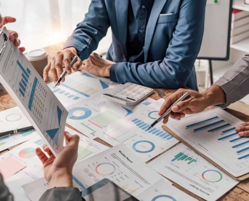 Image of business people analyzing charts of energy costs.