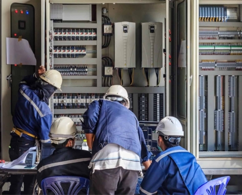 Image of workers performing maintenance on building electrical systems